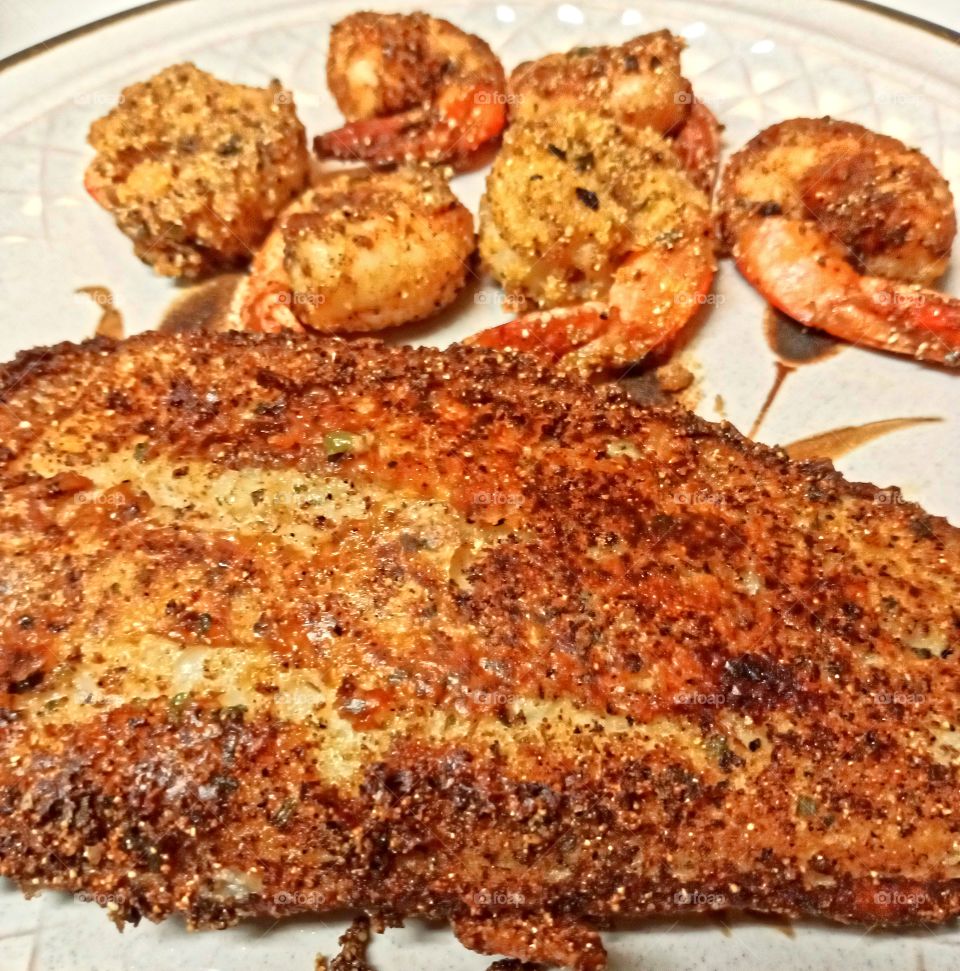 Swai fish and jumbo shrimp, lightly seasoned with a special seasoning and lightly coated with cornmeal. fried in a combination of canola oil and olive oil tell golden brown.