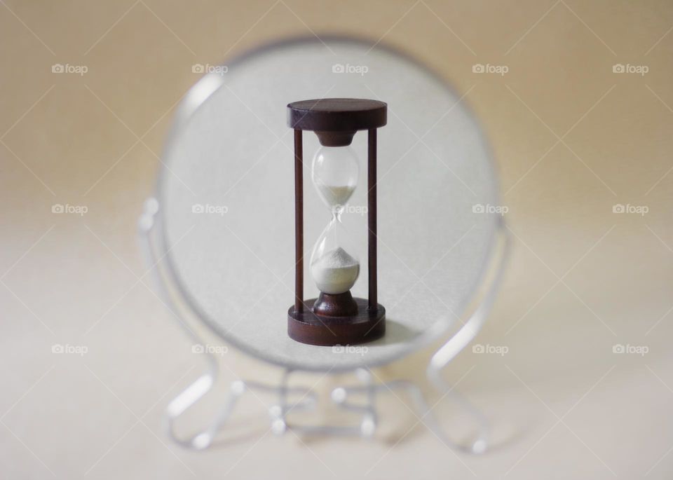 Circle shape of a mirror and a sand clock