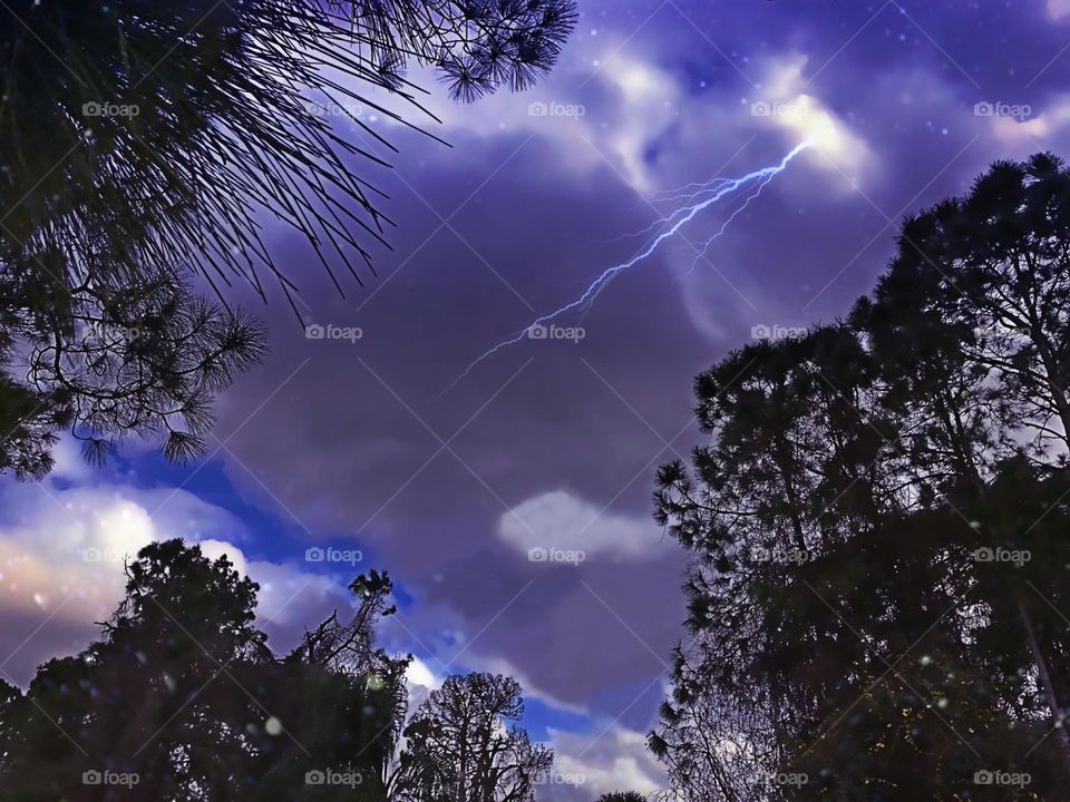 Lightning bolt through purple clouds.