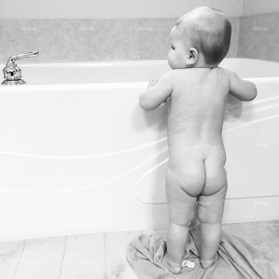 Bath Time Beauty. Baby standing up getting ready for bath. 
