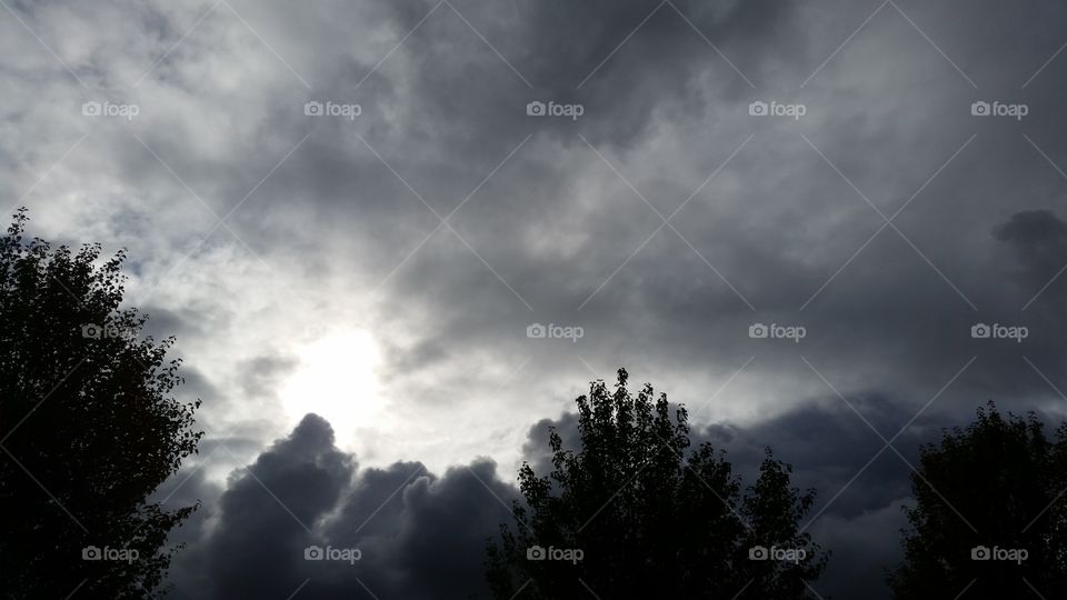 sun behind stormy clouds