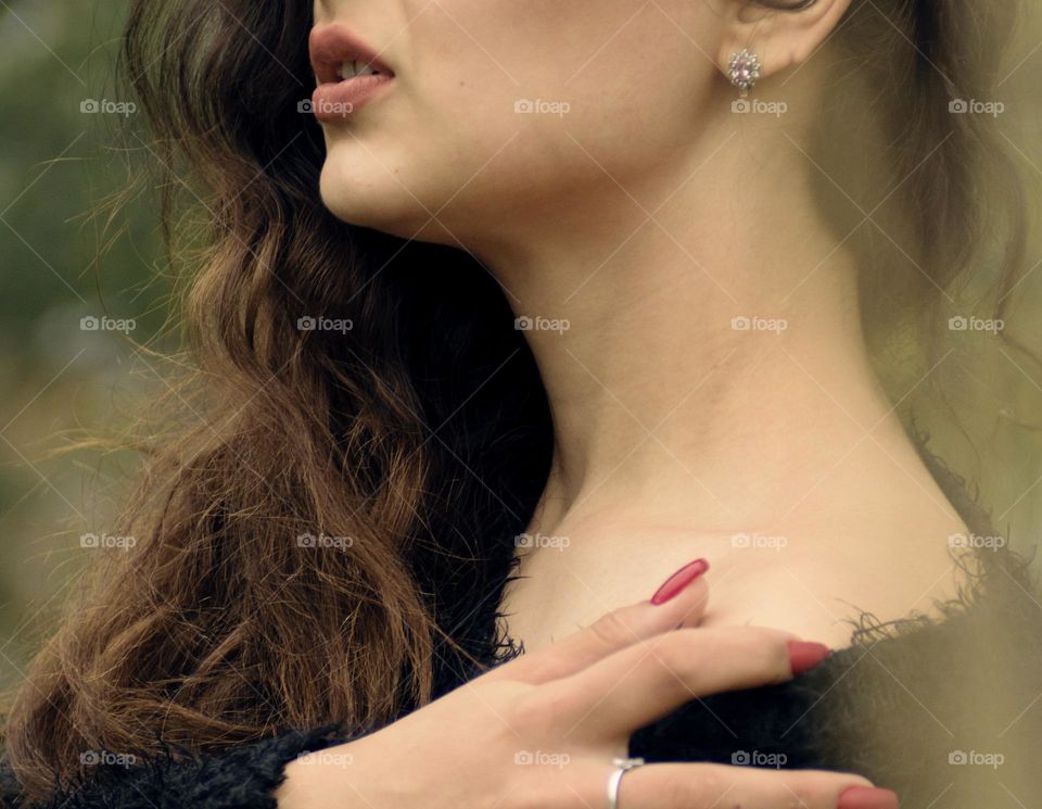 Girl with beautiful curly hair in the autumn park.