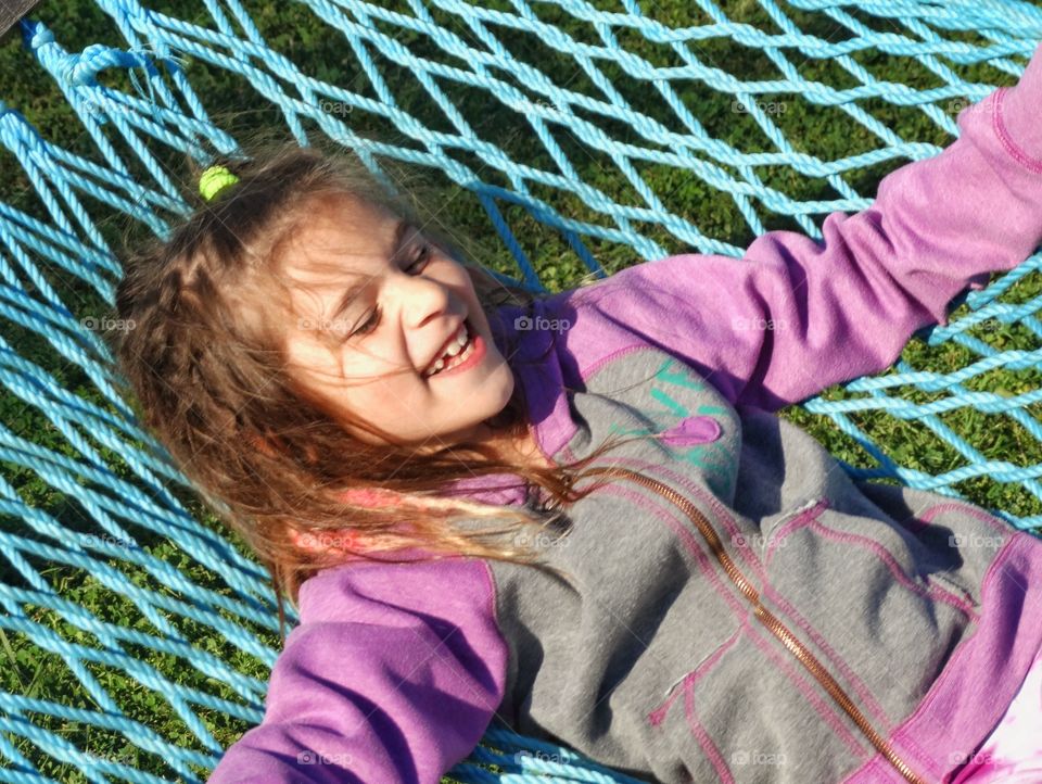 Happy Girl In A Hammock