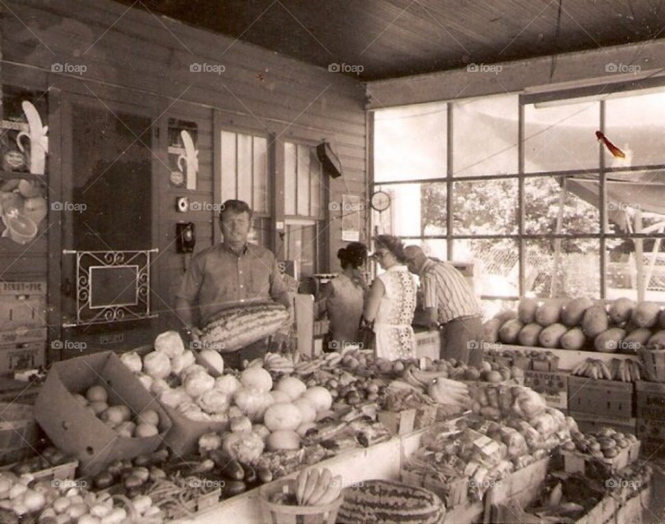 Group of people purchasing vegetables in store