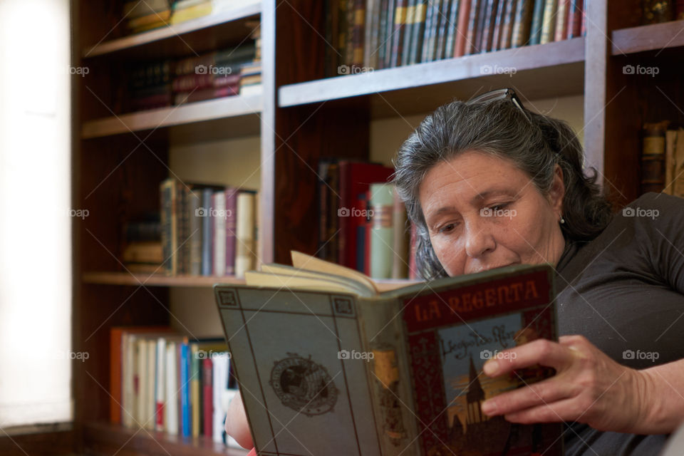 Mature woman reading book