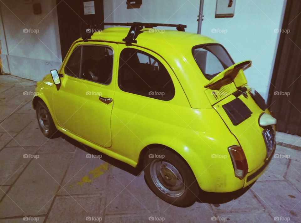 Tiny old yellow car in Presicce, Italy