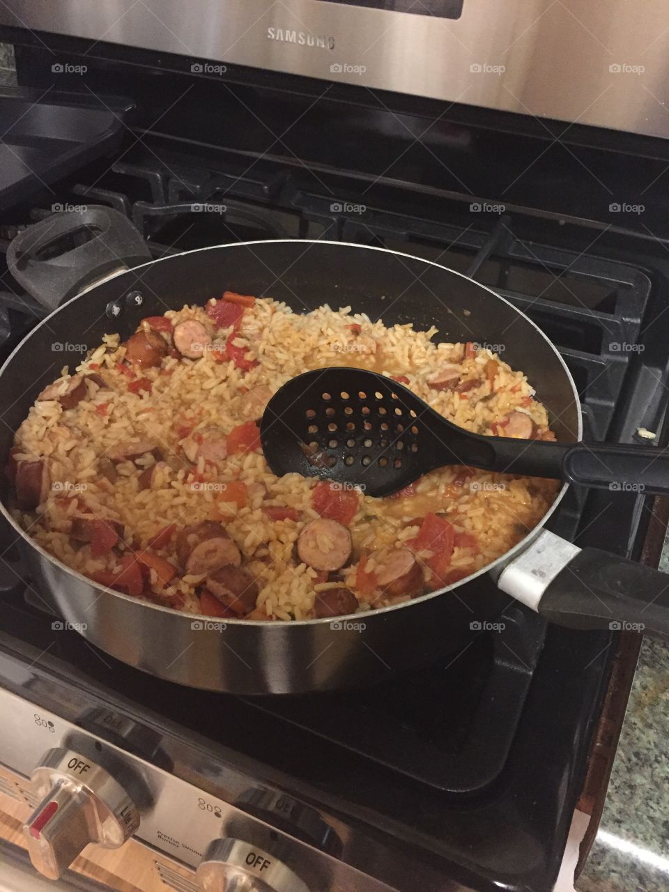 Dirty rice and sausage meal in a pan on stove. 