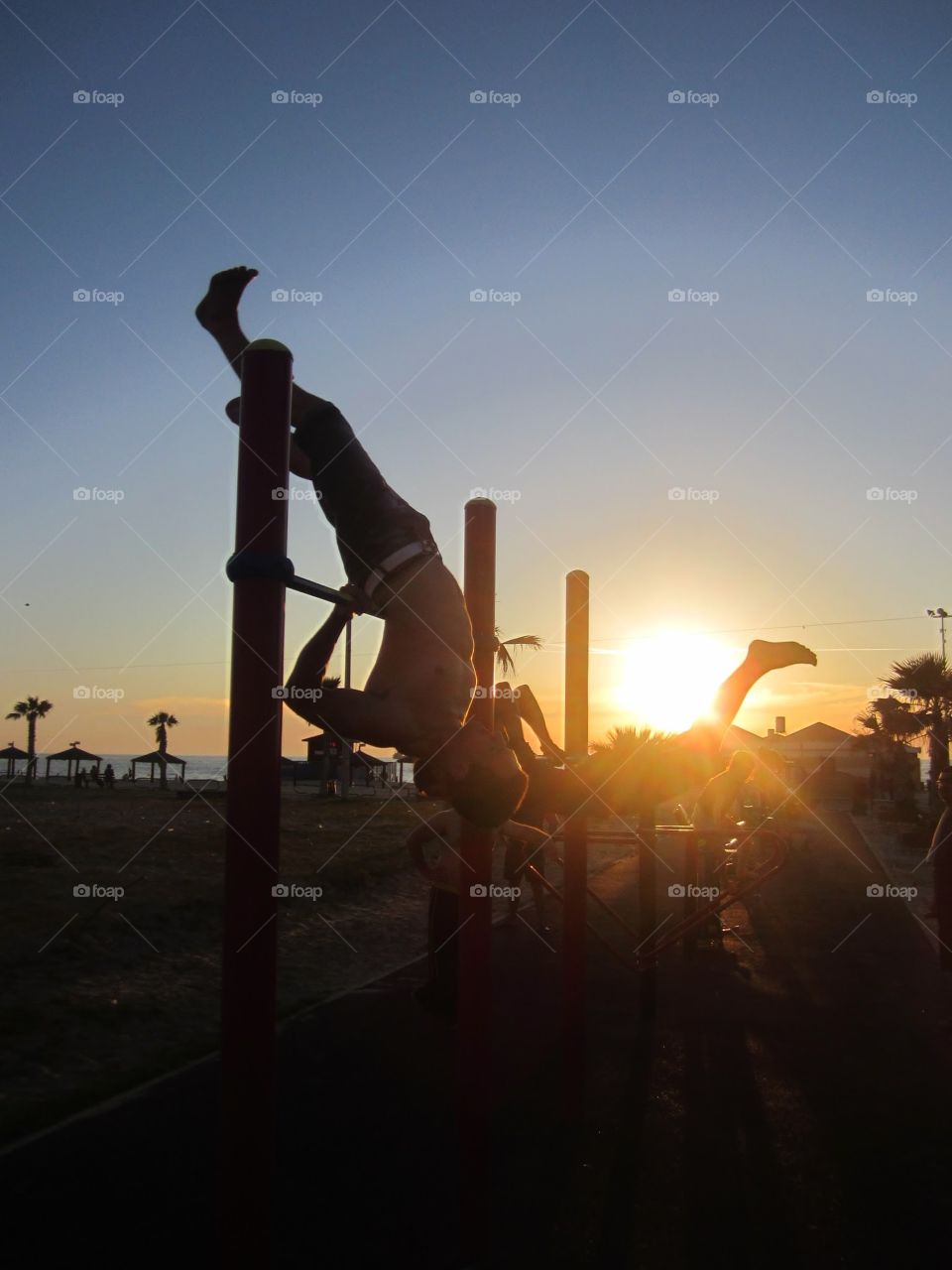 horizontal bar . athletic group on horizontal bar and sun light