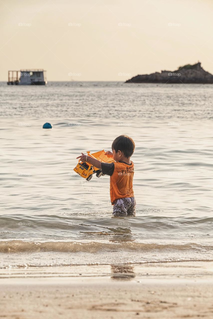 Kid enjoy in the beautiful summer beach