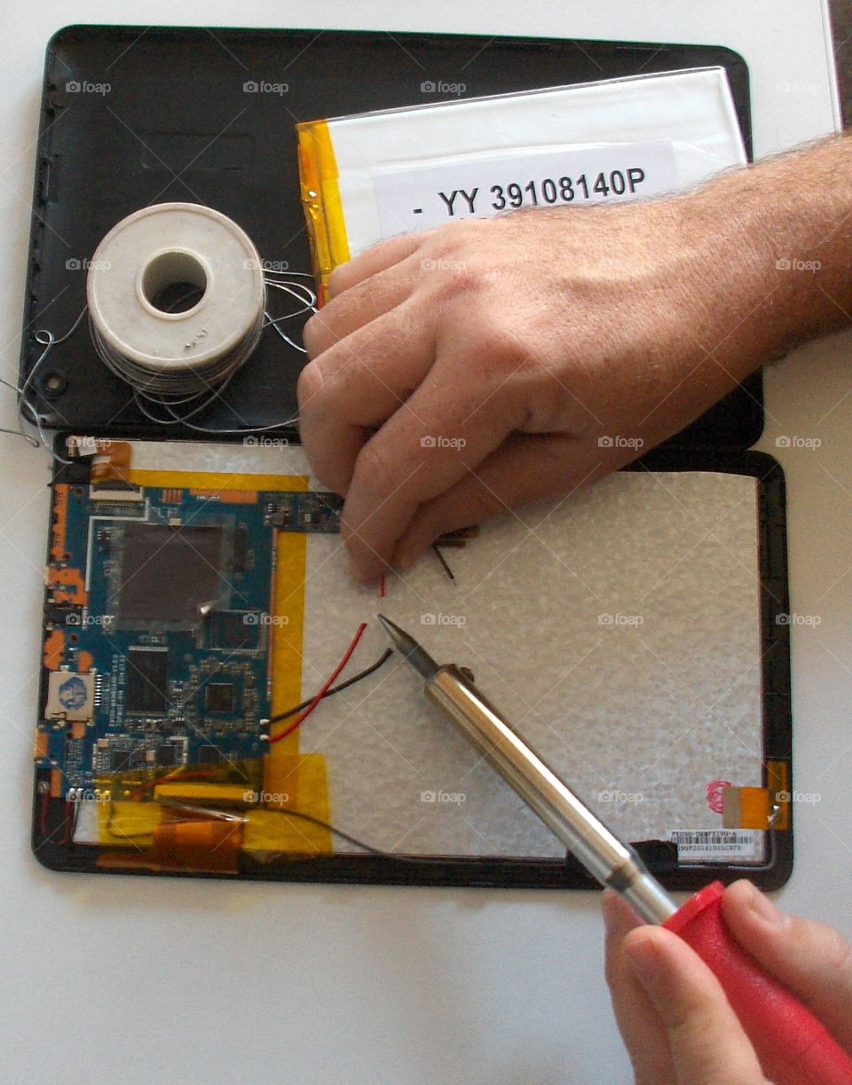 male hands fixing tablet pc