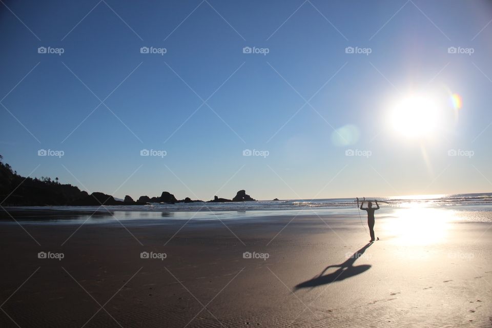 Surfer in the sun on beach