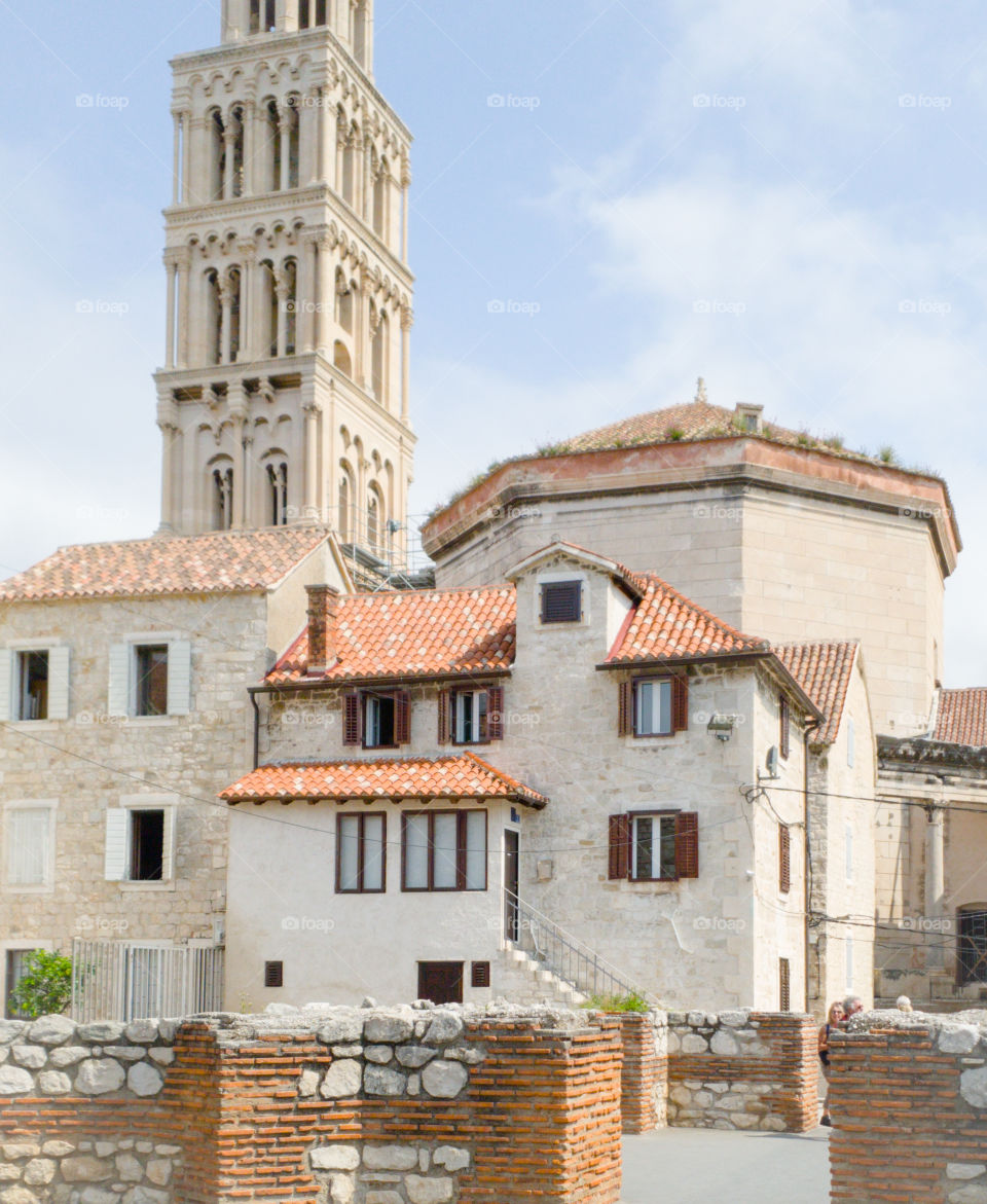 Summer landscape of an old medieval European city with stone houses with red tiled roofs and a tower.  Croatia, Split, Diocletian's Palace residential part