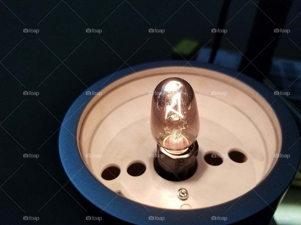 Exposed light bulb to a kid's lamp.