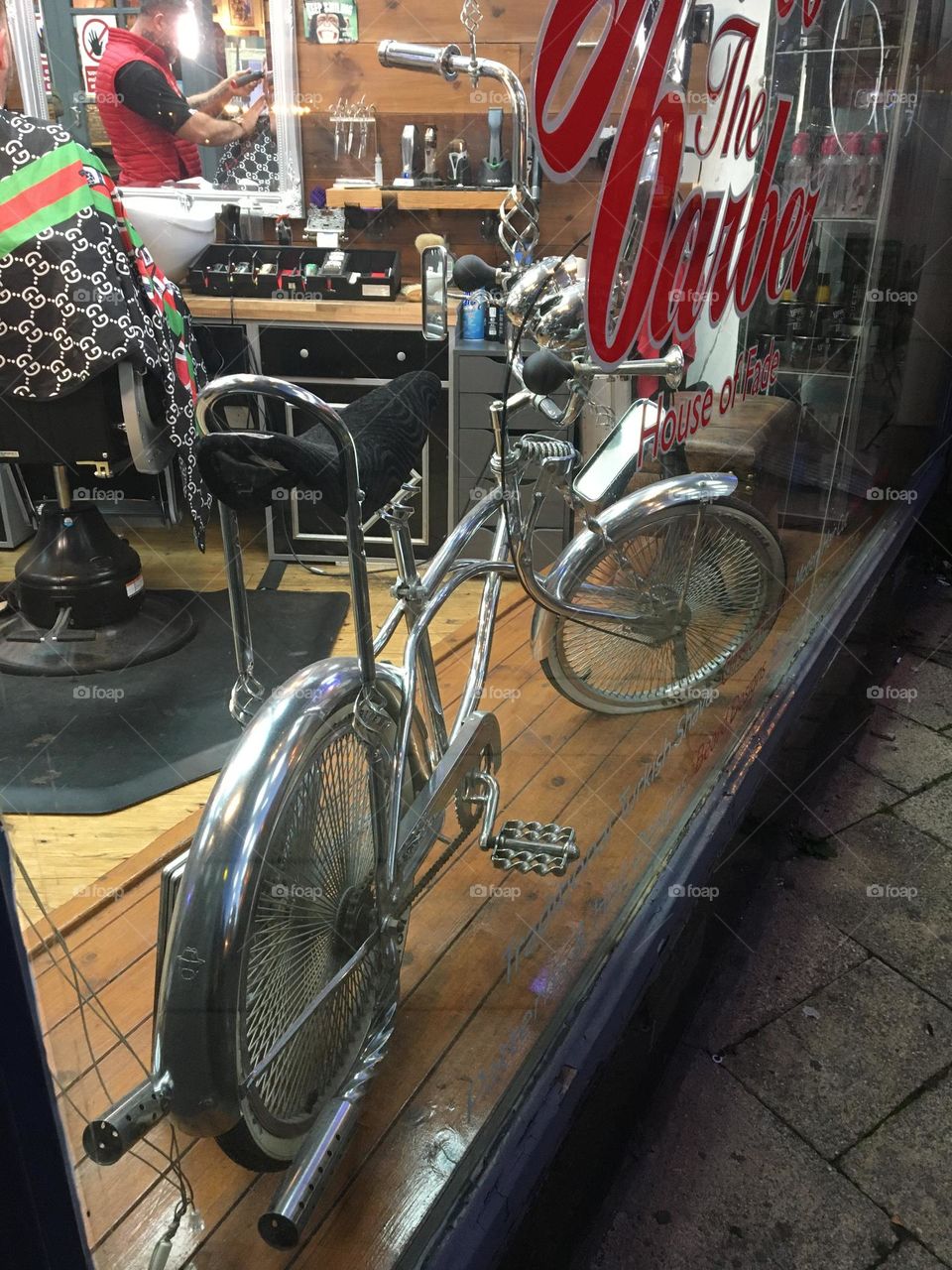 One lonely retro Chopper bike in a barber shop window 