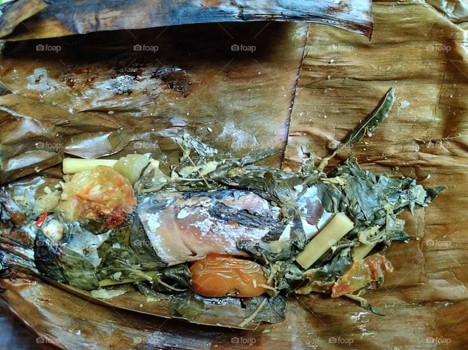 Steamed fish wrapped in leaves
