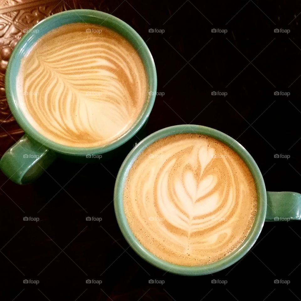 High angle view of coffee cup on wooden table