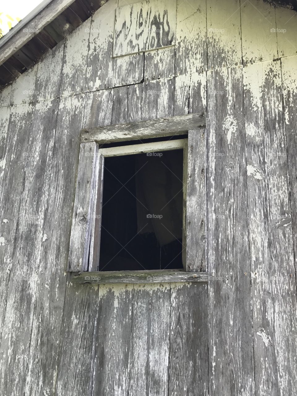 Open window of old weathered shed