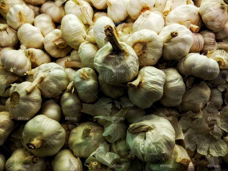 A mountain of garlic cloves sold at the local farmers market