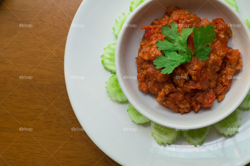 very famous Thai Northern Style paste dip called Nam Prik Ong.
spicy and yummy minced Pork with Tomato Relish and hot chilli pepper paste sauce.
together with vegetable like cucumber. 