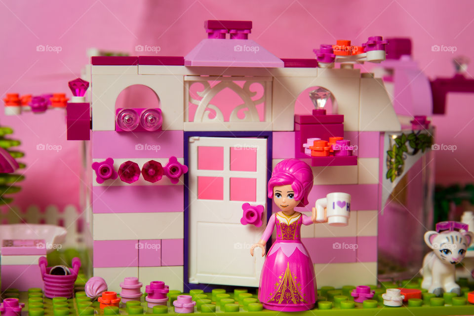 Pink! Image of pink and white Lego house, flowers, girl. Playful pink!