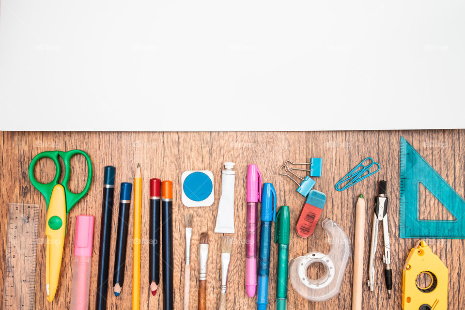 Top view of school accessories on a desk