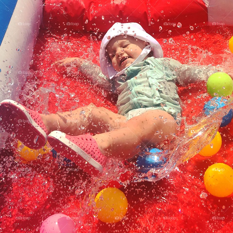 Cute girl falling from water slide