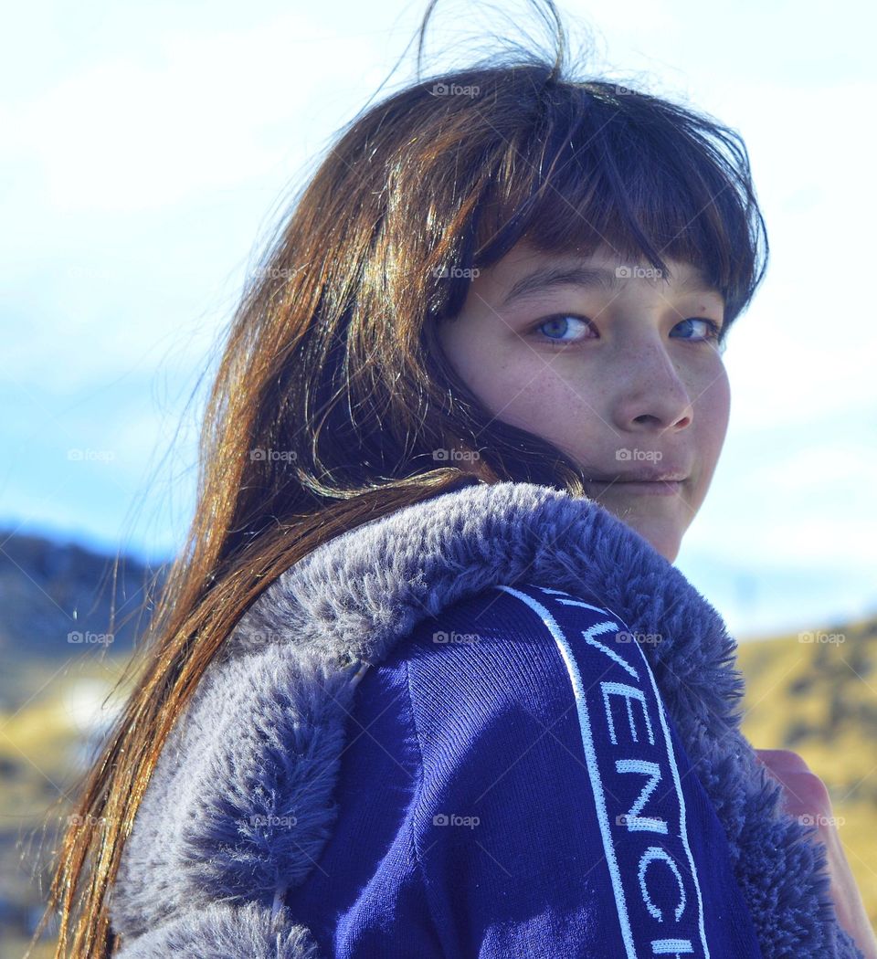 girl with blue eyes of Asian appearance. photo against the backdrop of the Pamir mountains.