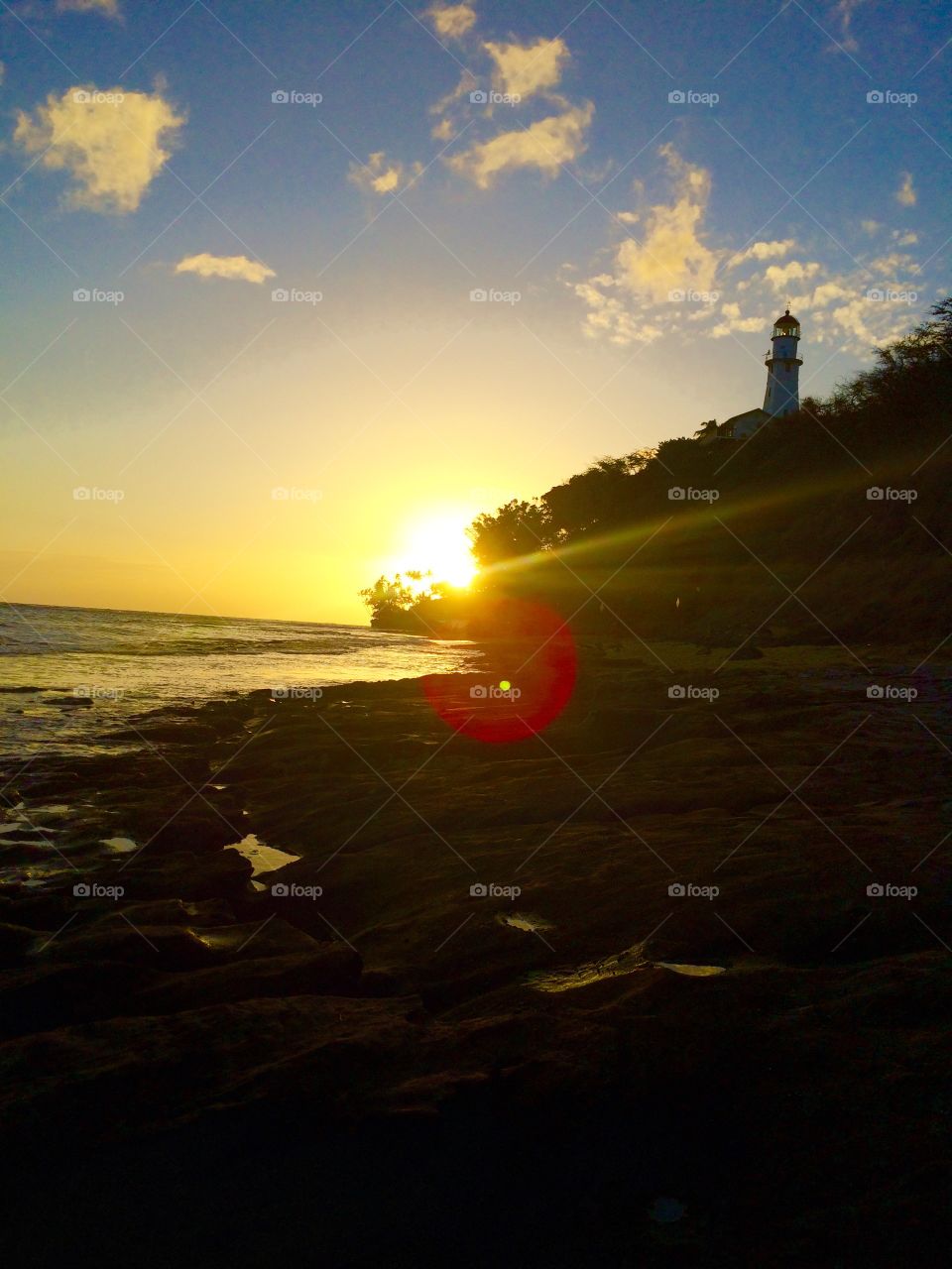 Lighthouse lookout. Below diamond head in Oahu Hawaii there is this rocky beach with a nice view of the lighthouse on an evening in May. 