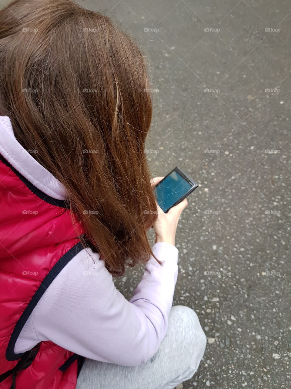 young girl typing on mobile phone