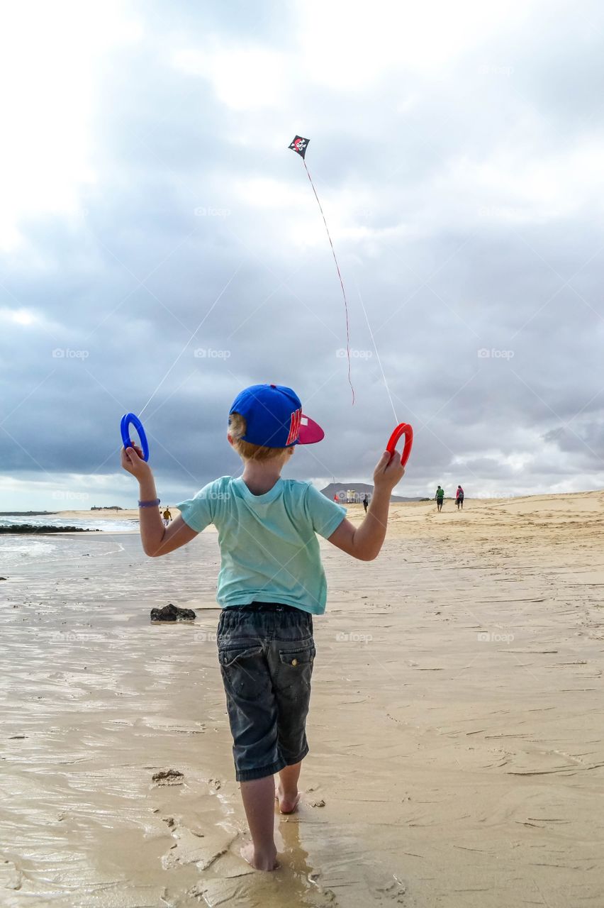 Little boy flying kite 