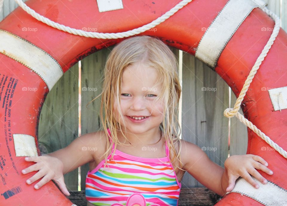 Portrait of a happy girl in inflatable tire