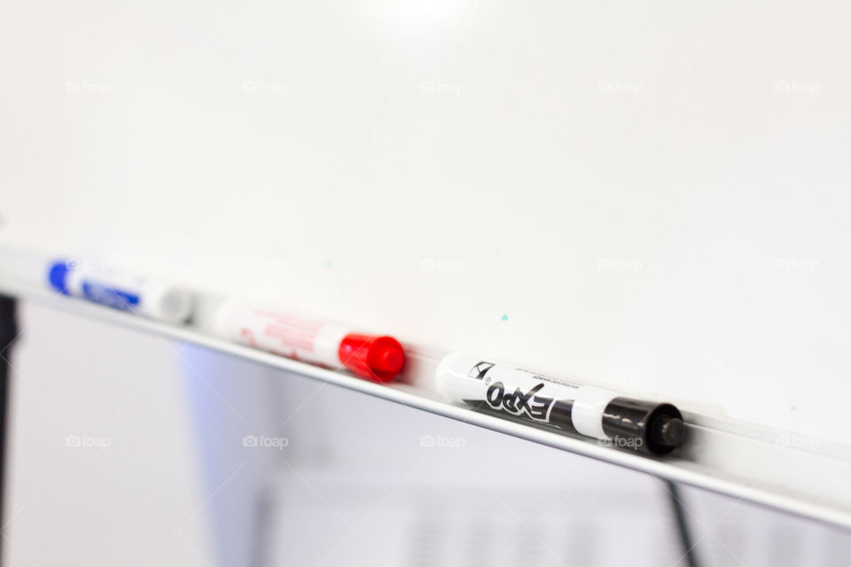 Markers and a whiteboard wait to be written on