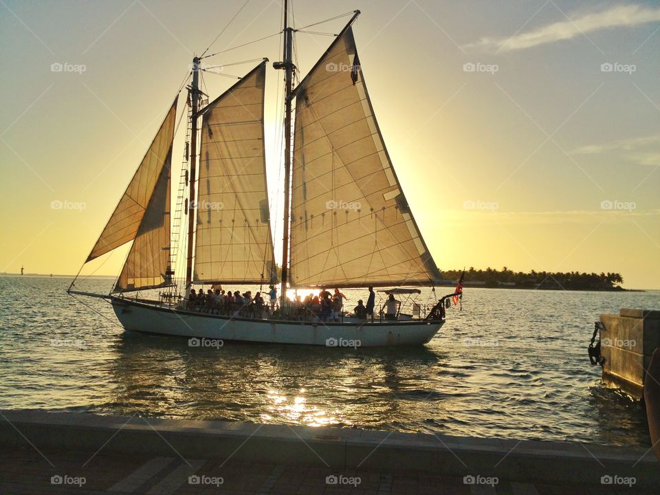A romantic sailing at sunset. A romantic sailing at sunset across key west