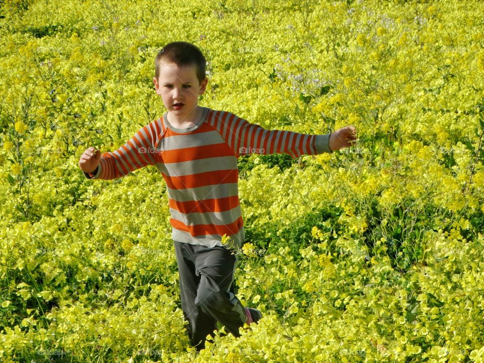 Boy Running Through Wildflowers 