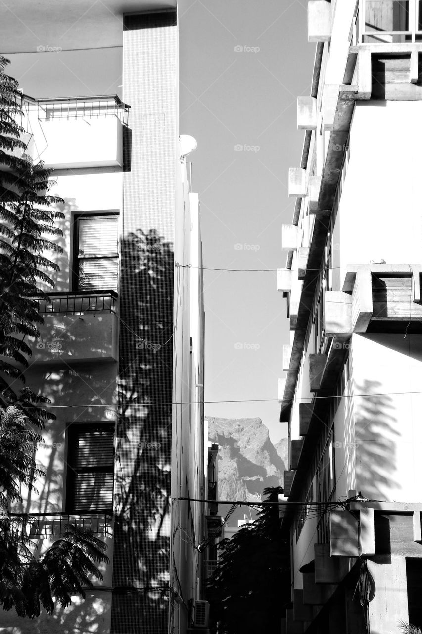 View through houses in a city on a mountain