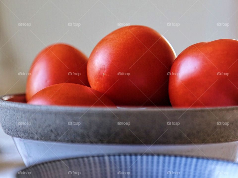 Red ripe tomatoes in a bowl