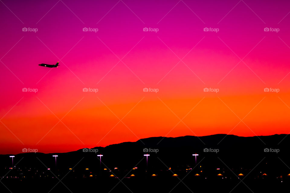Plane flying in sunset. Las Vegas, NV.