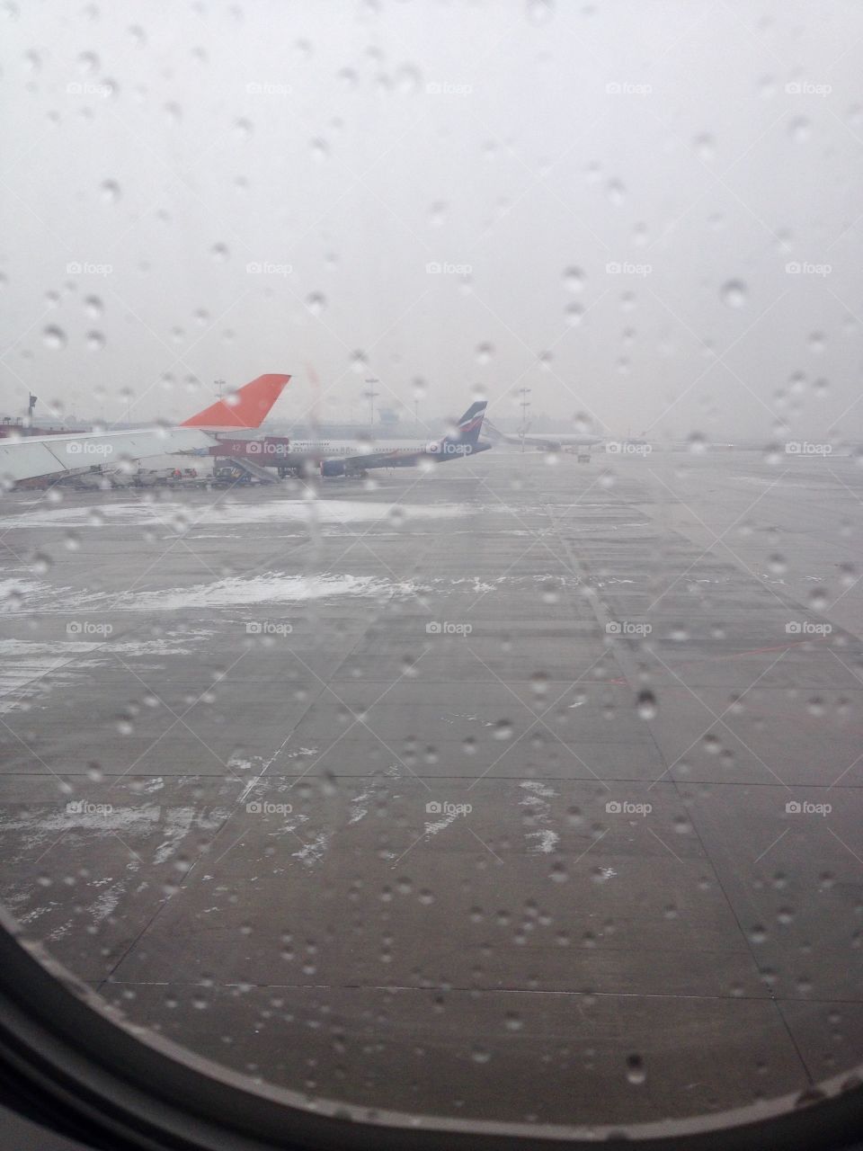 Rainy weather on an airport can be very disturbing, especially when you are going to fly away and it's winter