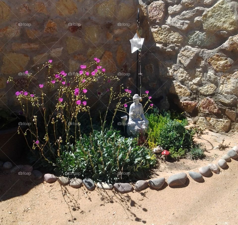 Silver Buddha Statue in a Garden