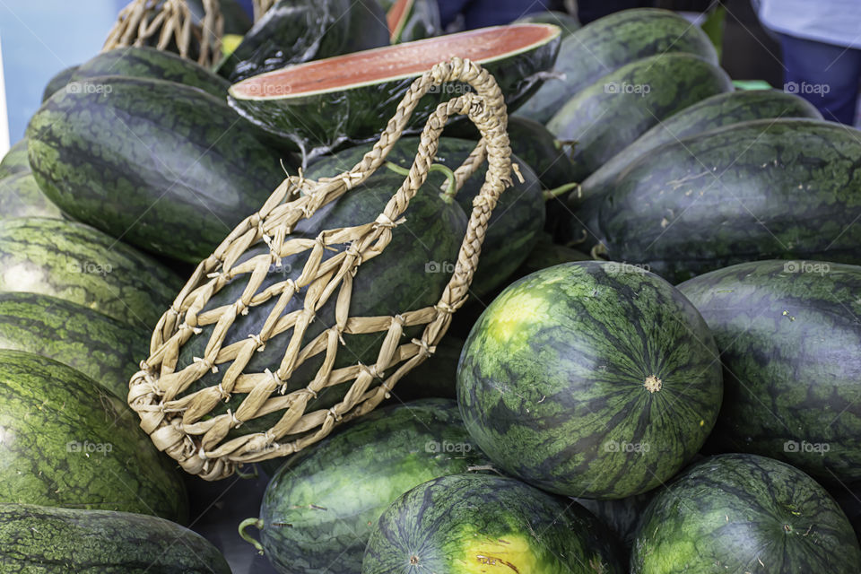 Watermelon lot on the table and put a hand basket