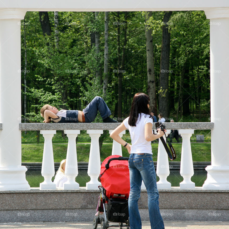 People have a rest. Children, mother with a stroller, camera