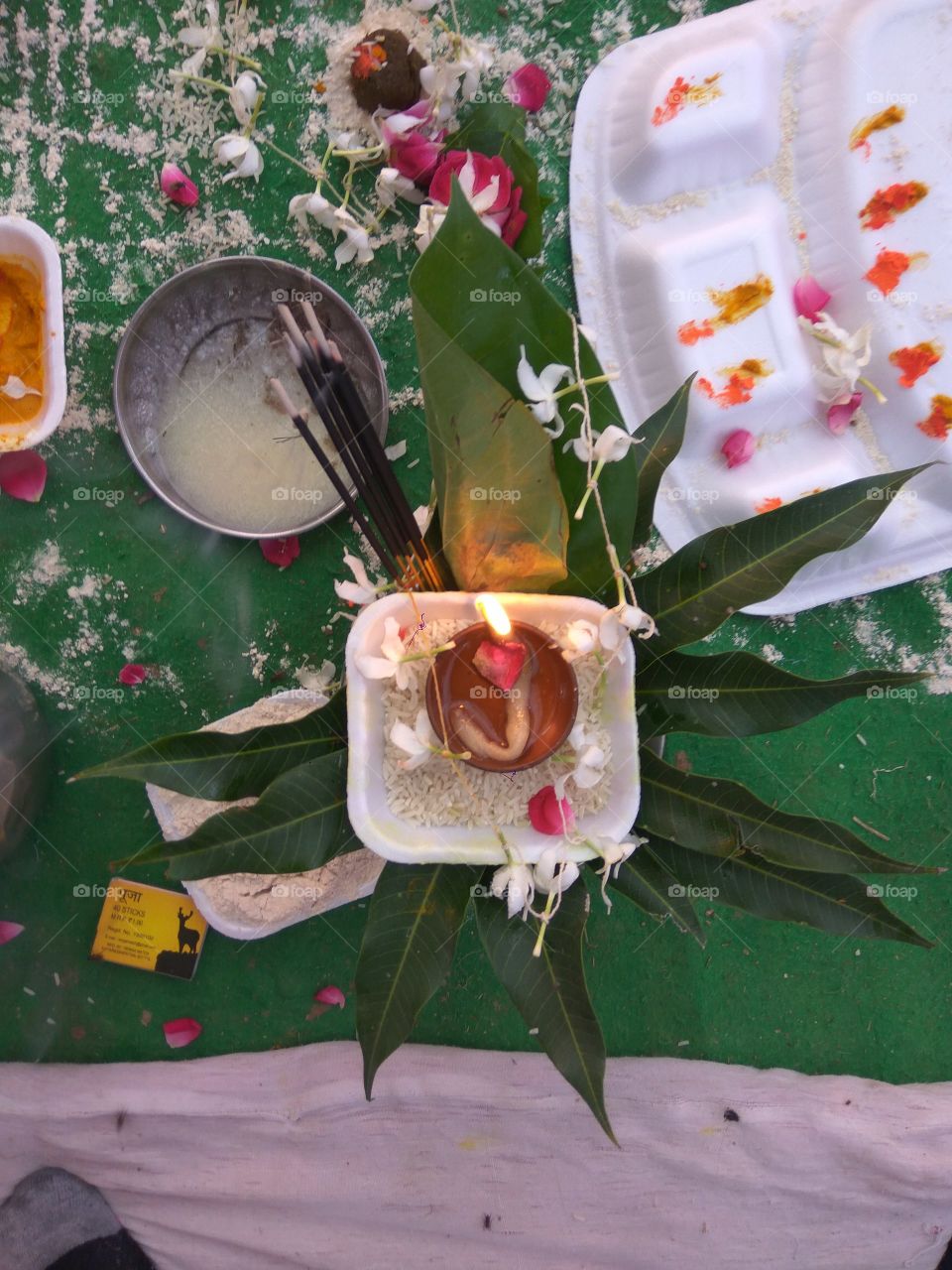 worship 
chirag
rice 
flowers 
agarbatti
mango tree lives