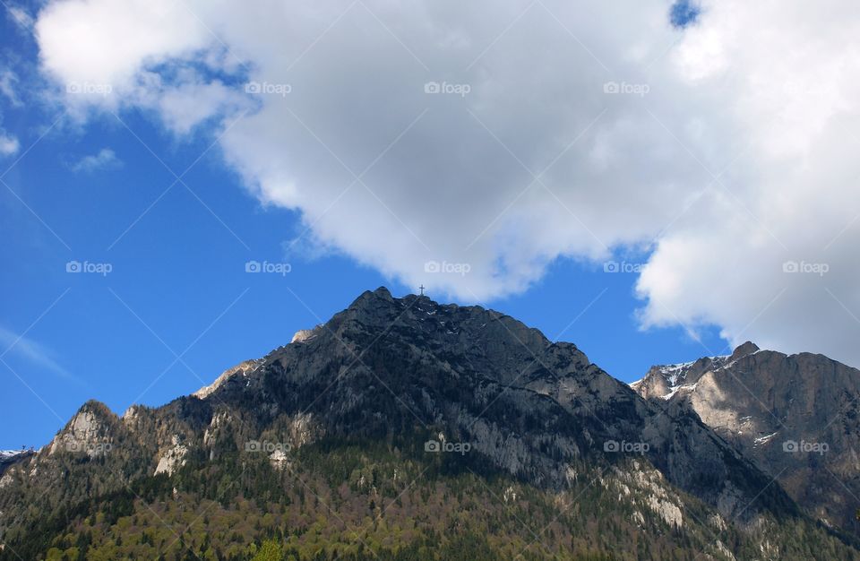 White clouds over Caraiman peak on a spring day in the Romanian Carpathians