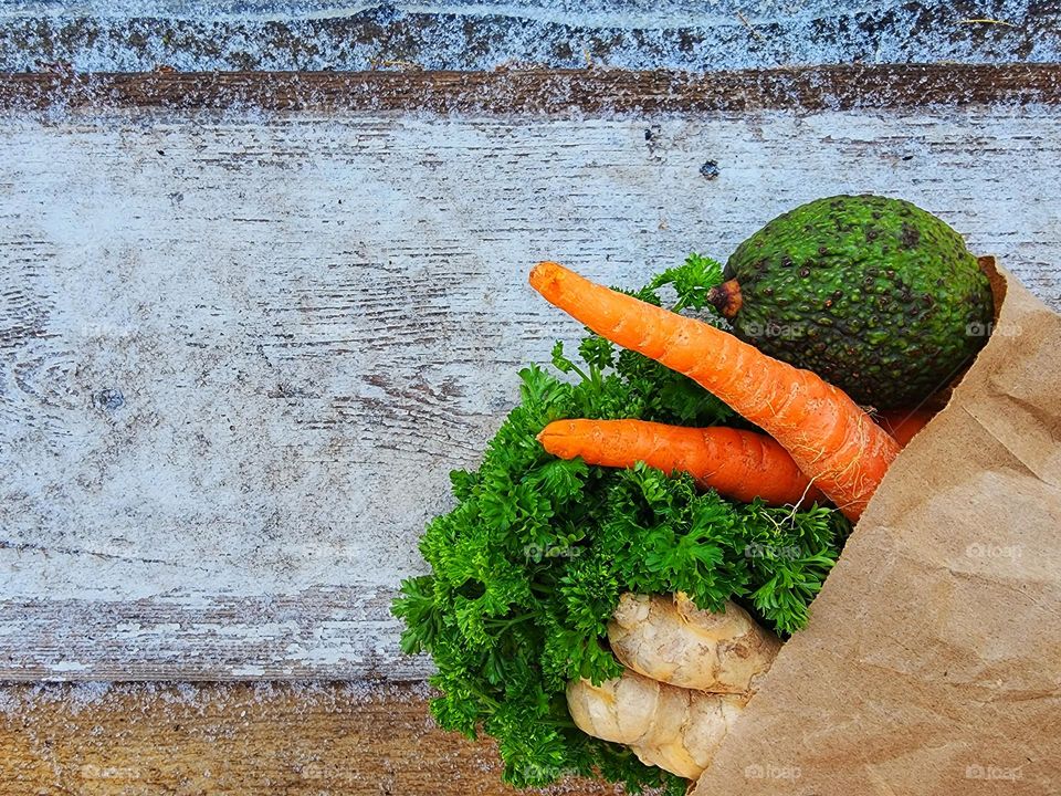 Brown paper bag filled with fresh produce.