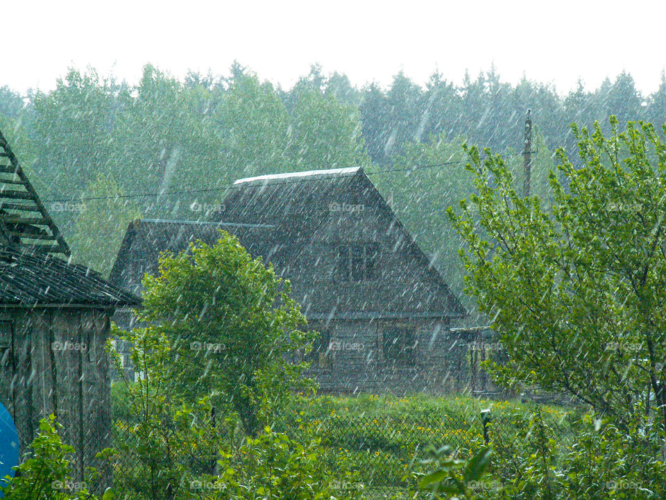 heavy rain in the village in the summer or spring