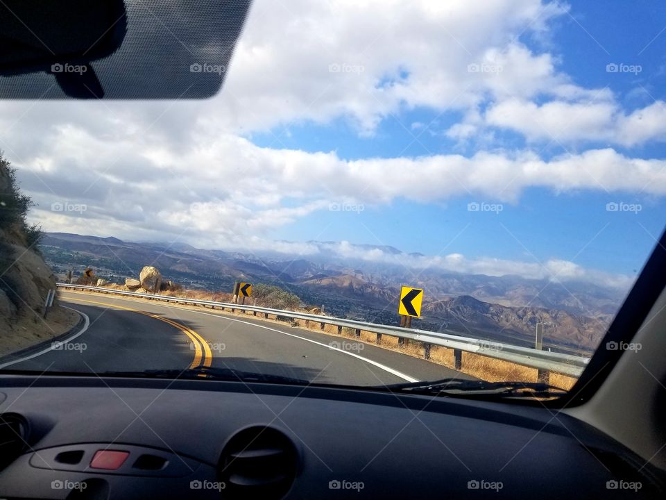 Mazda 2 interior on a roadtrip through California mountain pass.
Left turn arrow.