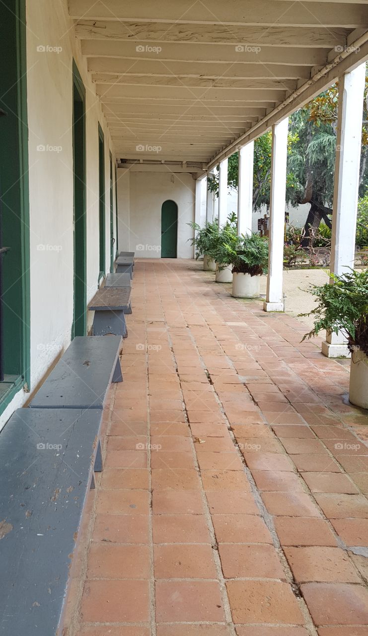 Inside the back courtyard of an old adibe mission style adobe built in the 1700s in Monterey, CA