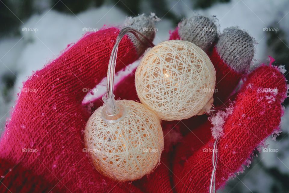 Christmas light balls in the glove hand winter holiday