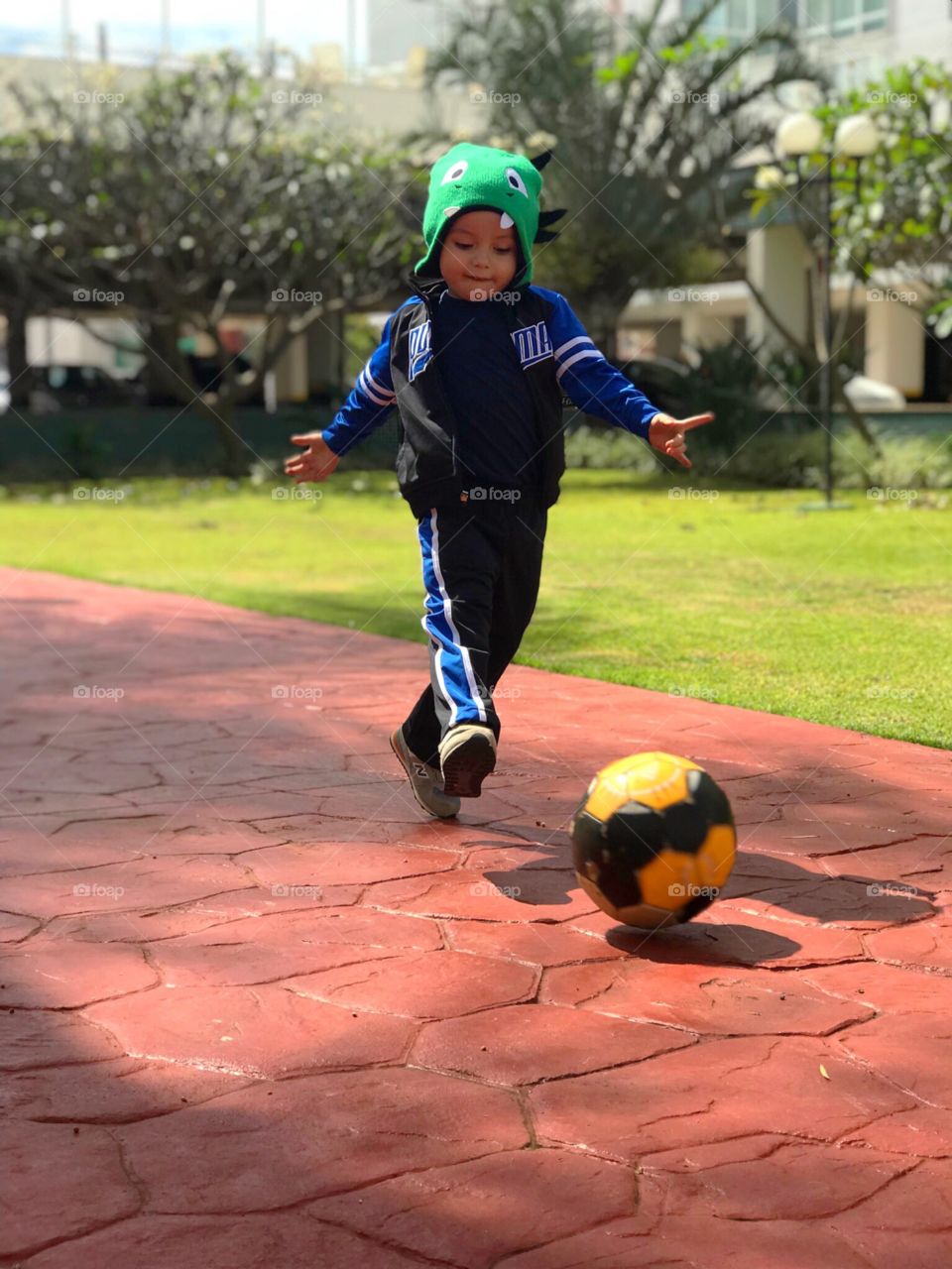 Kid playing ball in the playground 