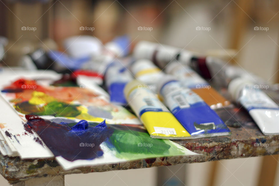 Paints and palette in a studio ready to be used by an artist